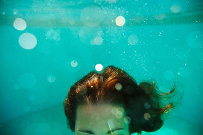 Close-up of woman swimming in pool