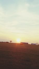 Scenic view of field against sky during sunset