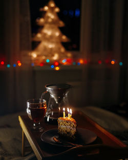 Illuminated christmas lights on table at night