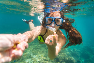 Portrait of young woman swimming in sea