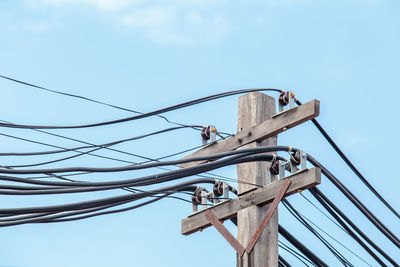 Low angle view of telephone pole against sky