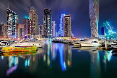 Reflection of illuminated buildings in city at night