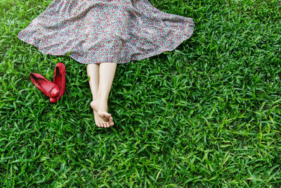 Low section of woman lying down on grass