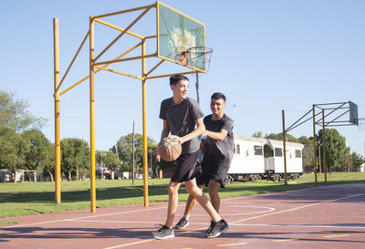 Portrait of teenage boys playing baskeball