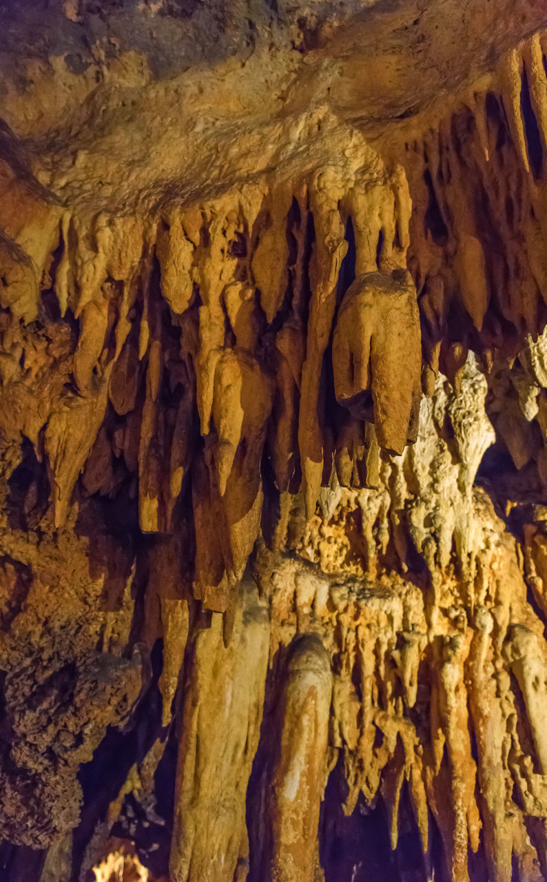 LOW ANGLE VIEW OF ROCK FORMATION AT CAVE