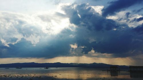 Scenic view of sea against cloudy sky