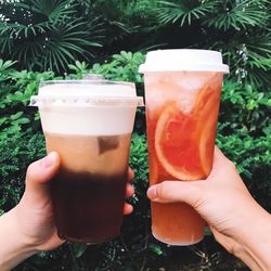 Close-up of hand holding beer glass