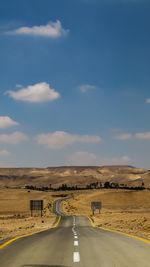 Empty road along countryside landscape
