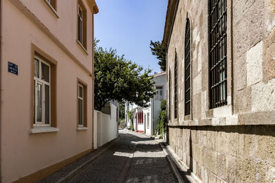 Narrow street amidst buildings against sky