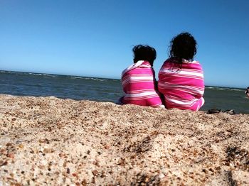 Rear view of man standing on beach