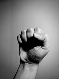 Close-up of fist against gray background