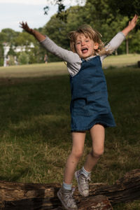 Full length of happy boy playing on field