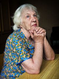 Thoughtful senior woman at home