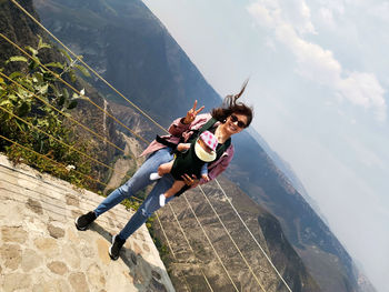 Young couple on mountain against sky