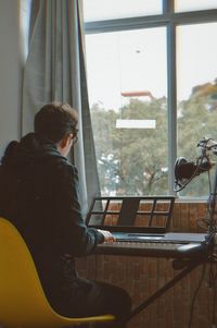 Man sitting on table at home