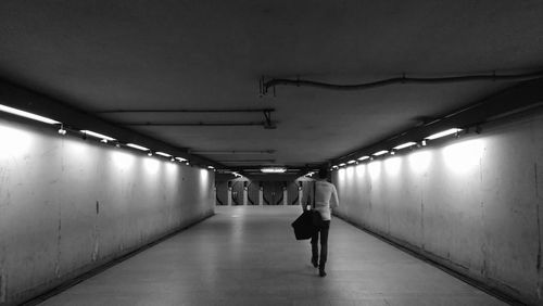 Rear view of woman walking in subway