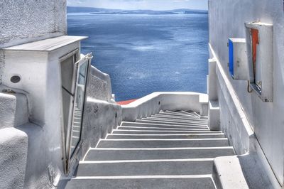 High angle view of staircase by sea against sky
