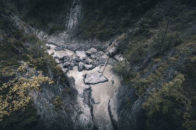High angle view of stream amidst rocks