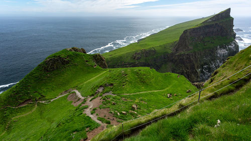 High angle view of land and sea against sky