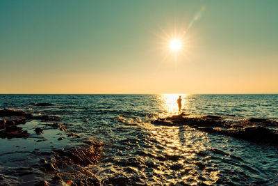 Scenic view of sea against clear sky during sunset