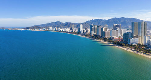 Panoramic view of sea and buildings against sky