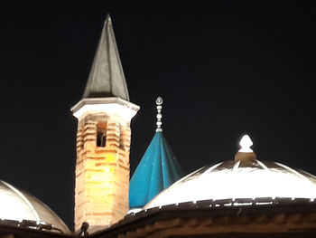 Low angle view of illuminated building against sky at night