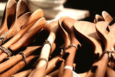 Close-up of tied wooden spoons at market stall