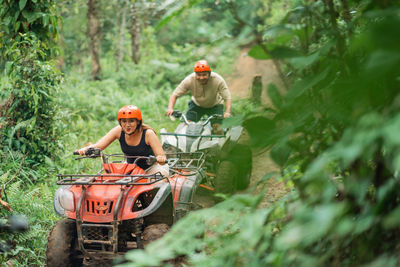 Rear view of man working in forest