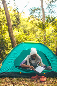 High angle view of man sitting in tent