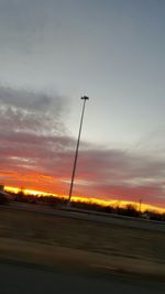 Silhouette of street light against sky at sunset