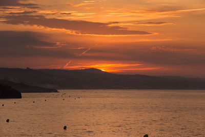 Scenic view of sea against orange sky