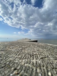 Surface level of beach against sky