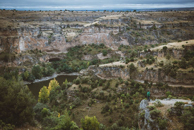 High angle view of man standing on cliff