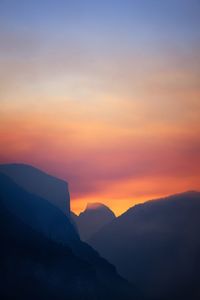 Scenic view of silhouette mountains against sky during sunset