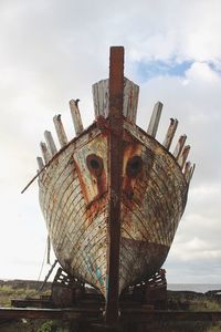 Low angle view of rusty ship against sky