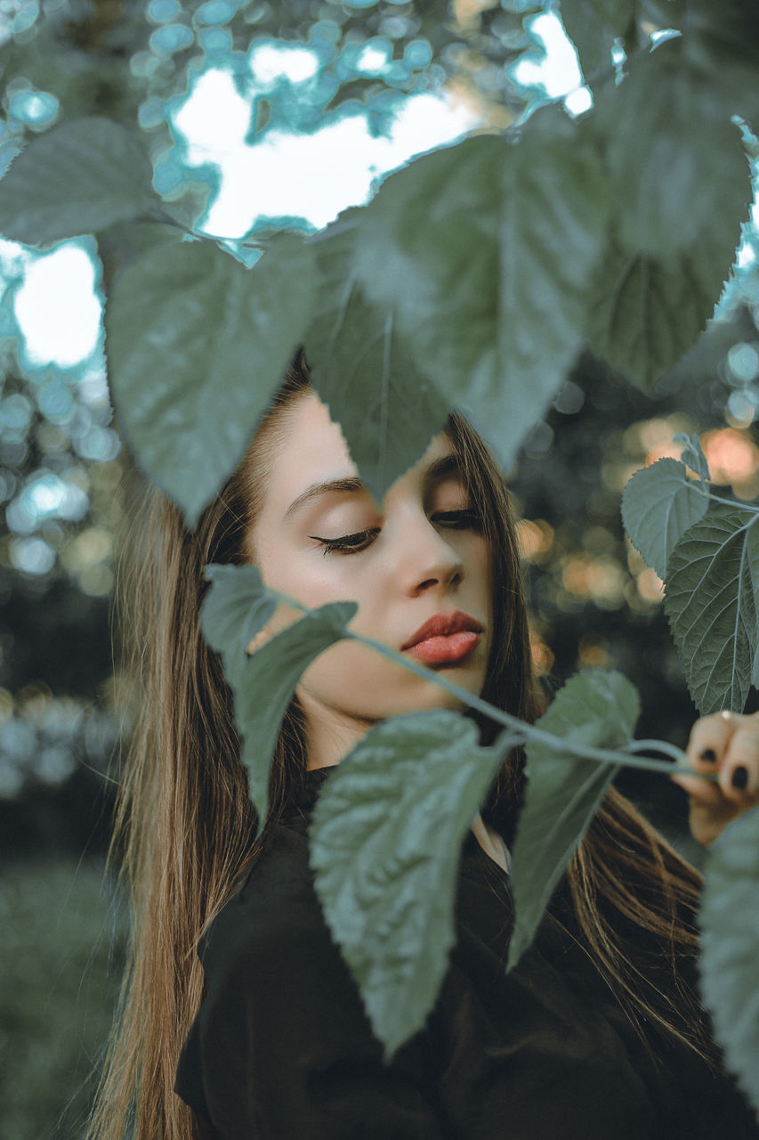 women, leaf, plant, plant part, tree, adult, young adult, nature, clothing, portrait, winter, spring, long hair, female, outdoors, beauty in nature, forest, looking, hairstyle, emotion, flower, green, fashion, autumn, togetherness, lifestyles, warm clothing, headshot, leisure activity, photo shoot, child, love, two people, teenager, smiling, land, day, brown hair, happiness, positive emotion