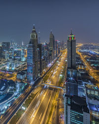 High angle view of illuminated city buildings at night