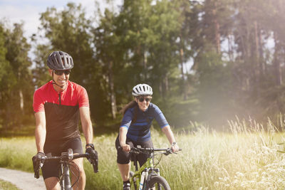 Smiling friends cycling together