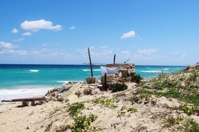 Scenic view of beach against blue sky