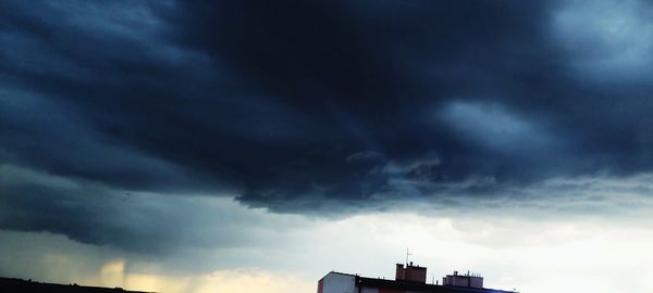 Low angle view of building against cloudy sky