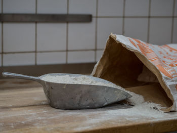 Close-up of cement in scoop on table at home