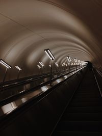 Illuminated railroad tracks in tunnel iphone 11