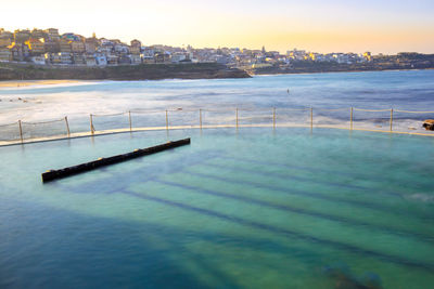 Scenic view of sea by city against sky