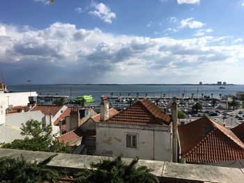 High angle view of townscape by sea against sky