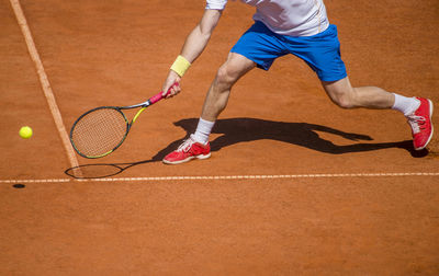 Low section of athlete playing tennis