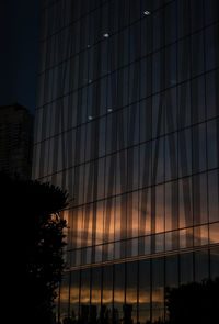 Low angle view of modern building against sky at night