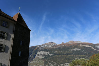Low angle view of buildings against blue sky