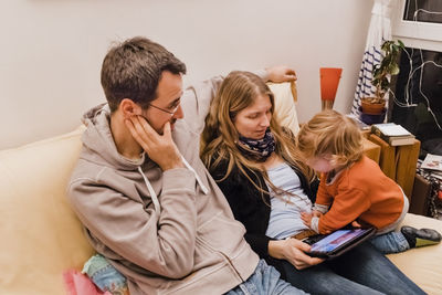 Family using digital tablet at home