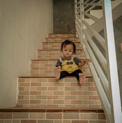 Cute girl sitting on staircase