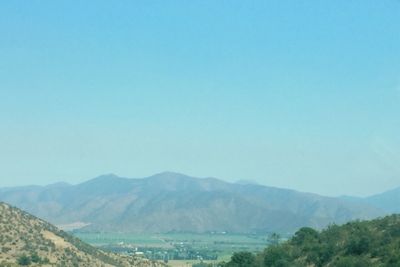 Scenic view of mountains against clear blue sky